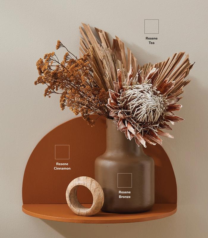A wooden shelf hanging on wall painted with various Resene paint colours