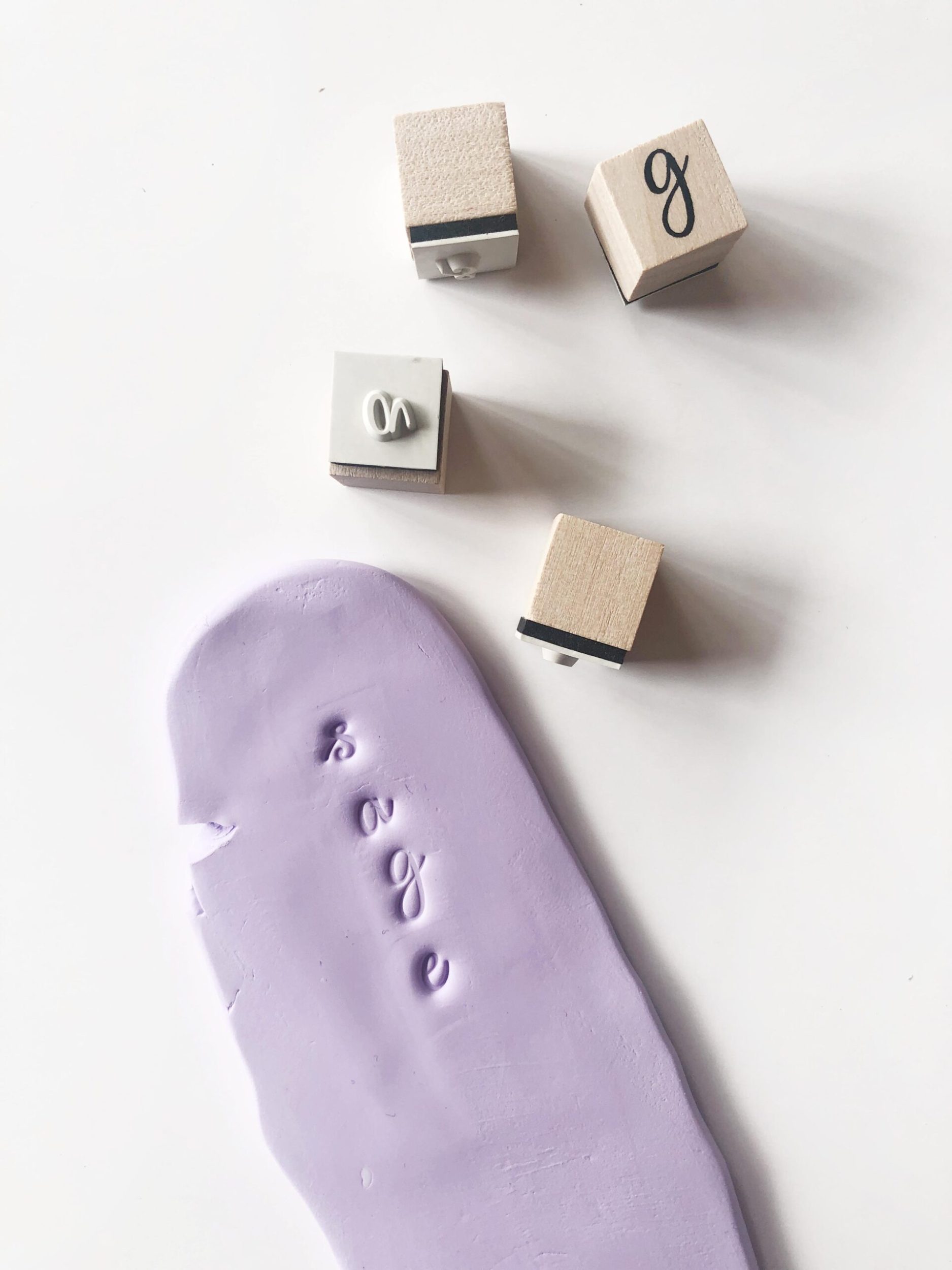 Soft clay and rolling pin and letter squares