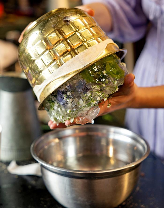 hands removing the ice bucket creation from its bowl