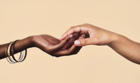 Two hands reaching out to touch