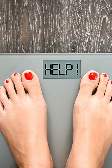 Lose,Weight,Concept,With,Person,On,A,Scale,Measuring,Kilograms