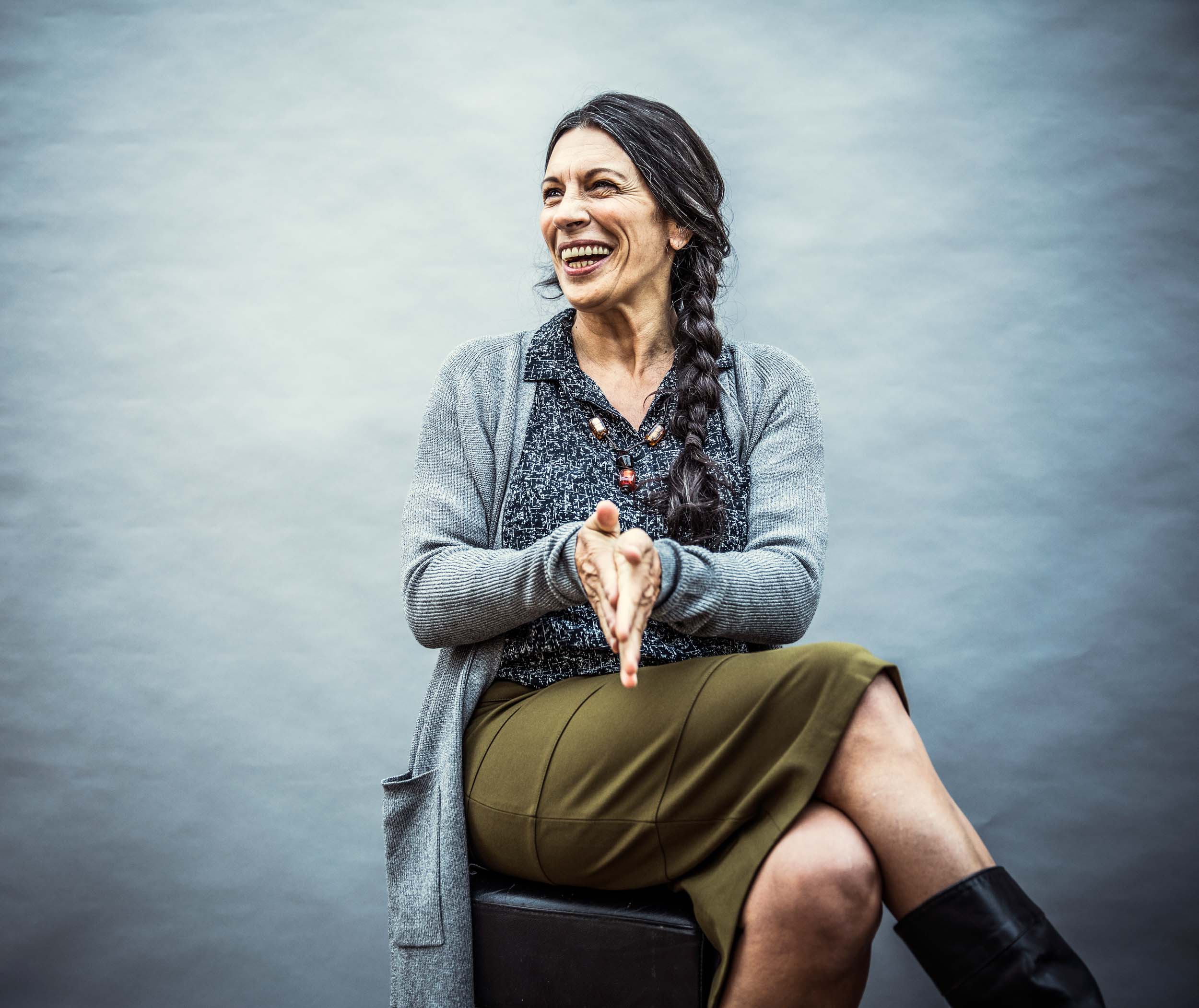 a smiling woman sitting down