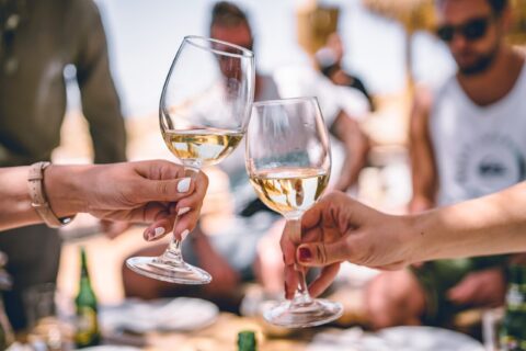 Hands holding wine glasses