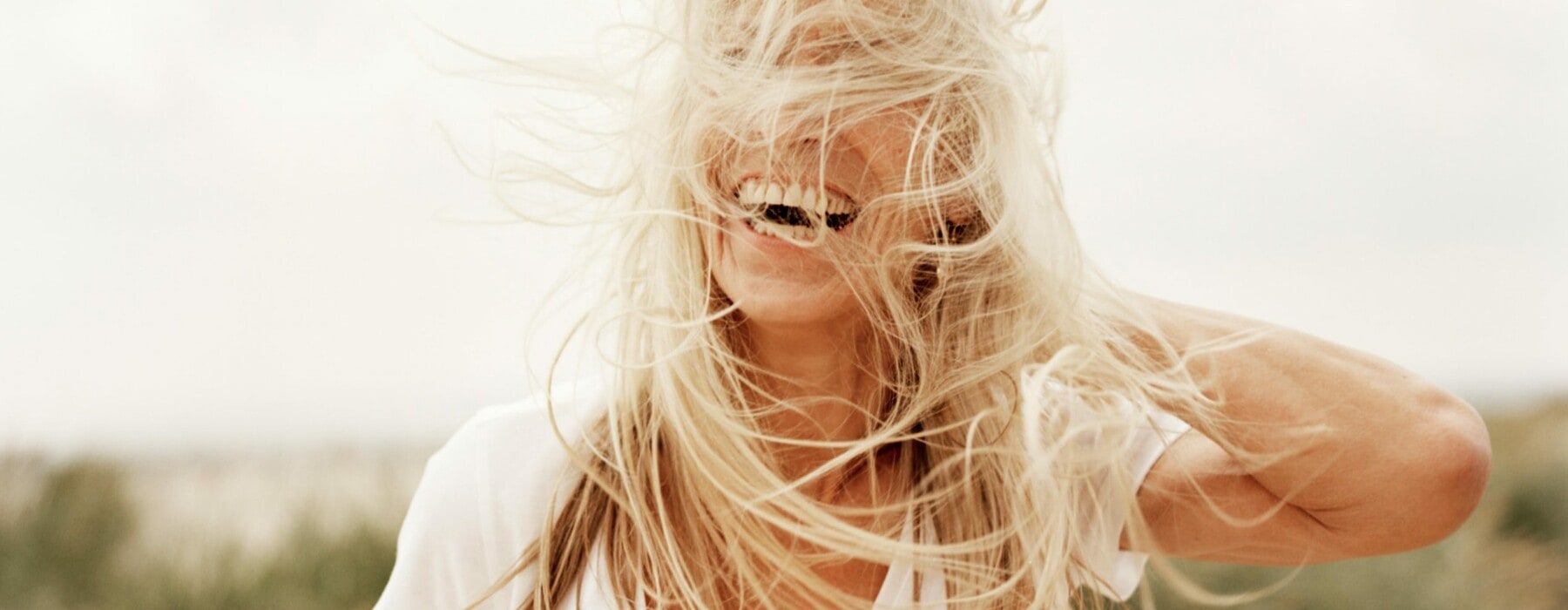 older woman with long hair blowing in the wind