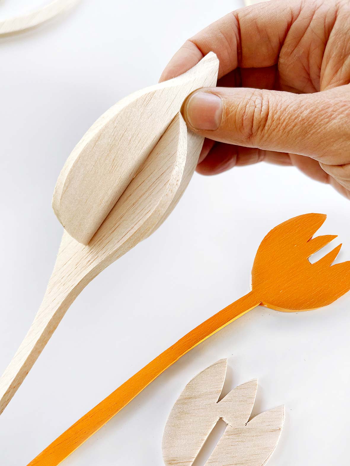 wooden flower cutouts being slotted together